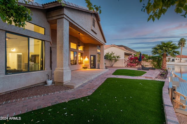 yard at dusk featuring a patio area