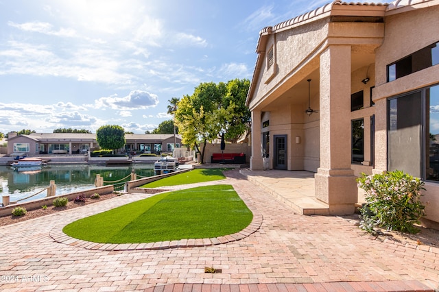 view of yard featuring a water view and a patio area