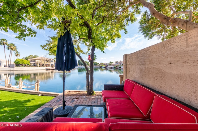 view of patio / terrace with a water view and outdoor lounge area