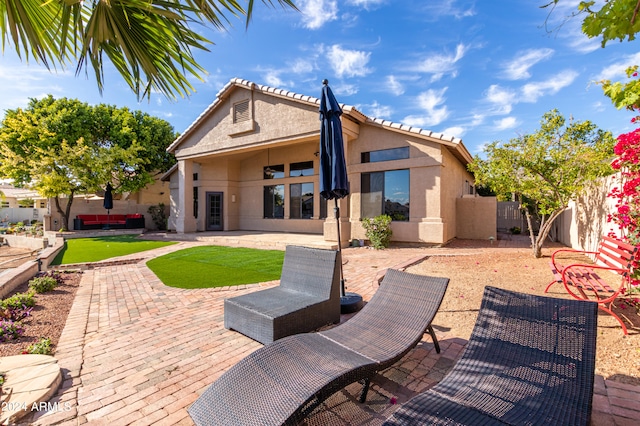 back of house with a patio