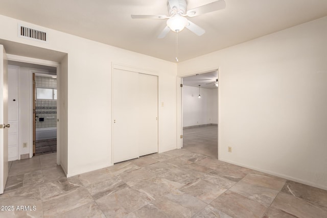 unfurnished bedroom with ceiling fan and a closet