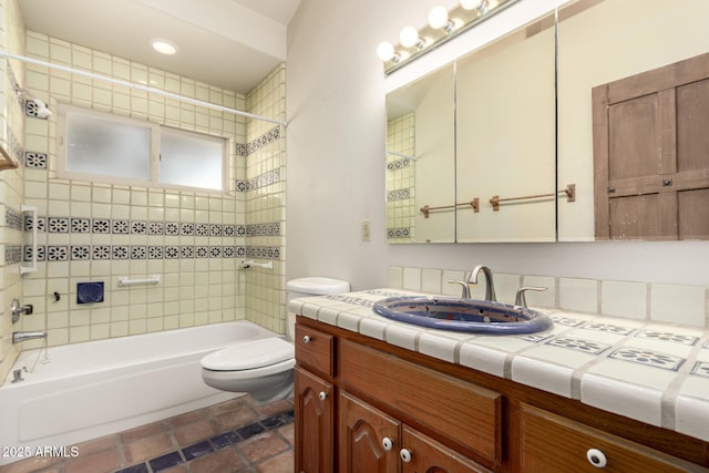 full bathroom with vanity, tiled shower / bath, and toilet