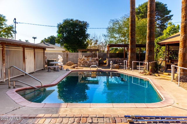 view of swimming pool with exterior bar, a patio area, and central air condition unit