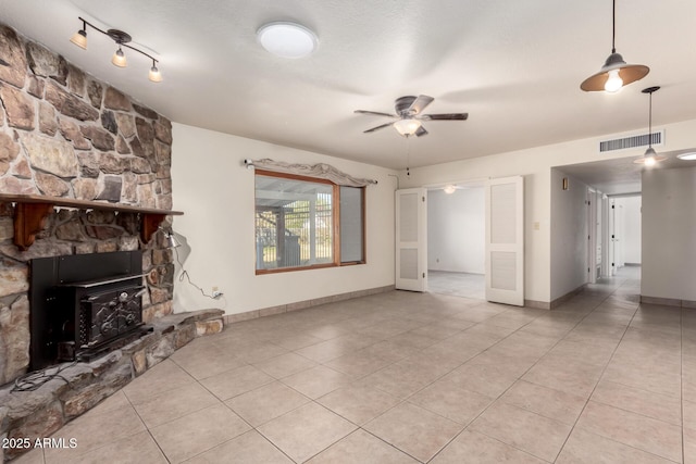 unfurnished living room featuring light tile patterned flooring and ceiling fan