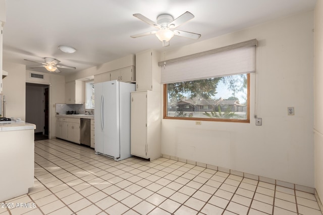 kitchen with white cabinetry, dishwasher, backsplash, white fridge, and ceiling fan