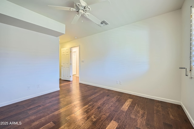 spare room featuring ceiling fan and dark wood-type flooring