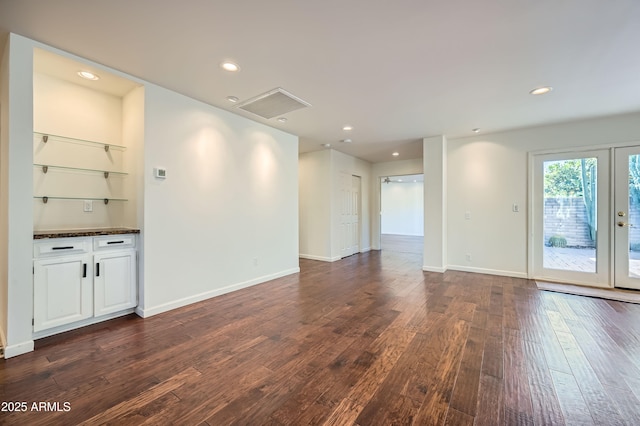 empty room featuring dark wood-type flooring and french doors