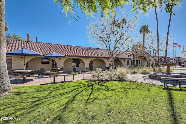 rear view of property with a lawn