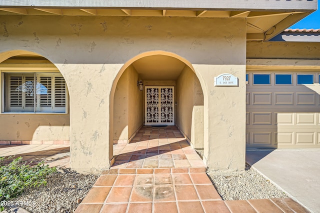 view of exterior entry with a garage