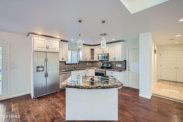 kitchen featuring white cabinetry, pendant lighting, a center island, and stainless steel appliances