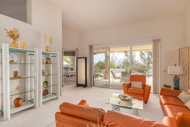 carpeted living area featuring high vaulted ceiling