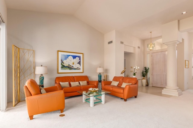 carpeted living area featuring high vaulted ceiling, visible vents, and ornate columns