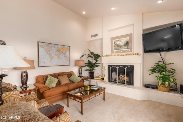 carpeted living area featuring high vaulted ceiling, recessed lighting, a fireplace with raised hearth, and visible vents