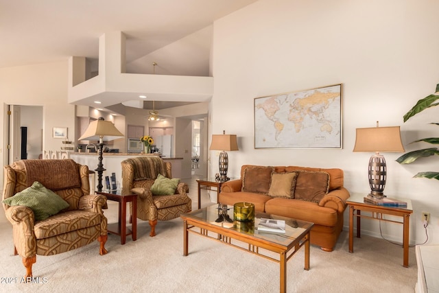 living room featuring high vaulted ceiling and carpet flooring