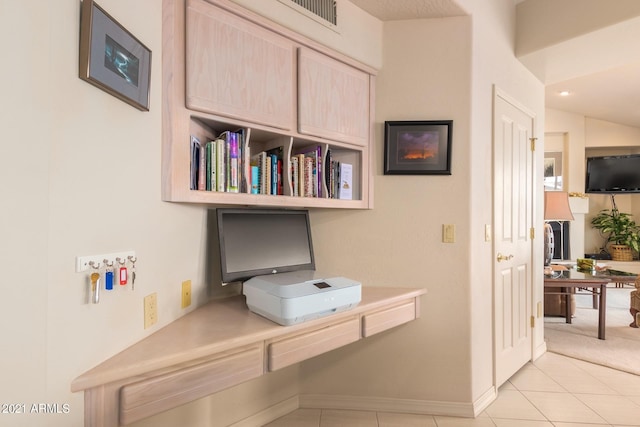 office space featuring light tile patterned flooring, visible vents, and baseboards