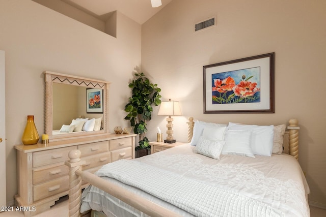 bedroom featuring vaulted ceiling and visible vents