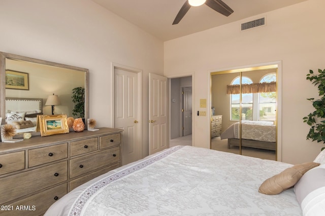 bedroom with visible vents, ceiling fan, and two closets