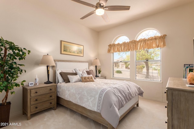 bedroom featuring a ceiling fan and light colored carpet