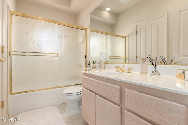 full bath featuring bath / shower combo with glass door, vanity, toilet, and tile patterned floors