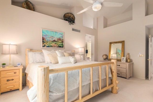 bedroom with high vaulted ceiling, light colored carpet, visible vents, and ceiling fan