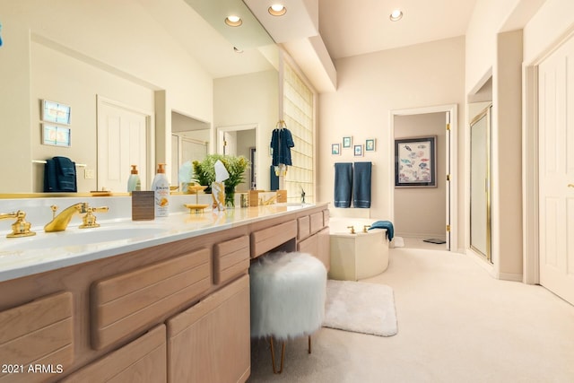 bathroom with double vanity, recessed lighting, a sink, a shower stall, and a bath