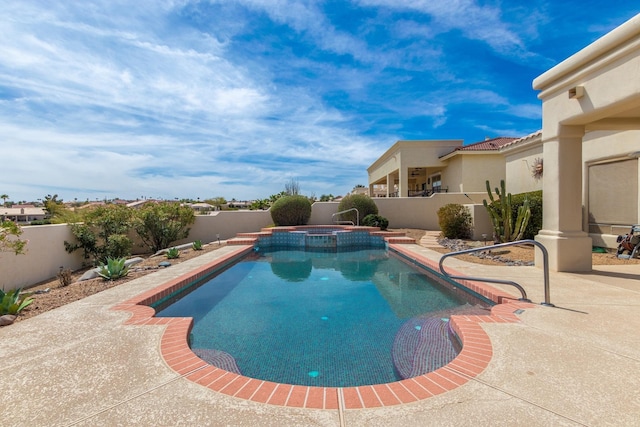 view of swimming pool featuring a patio area, a fenced backyard, and a pool with connected hot tub