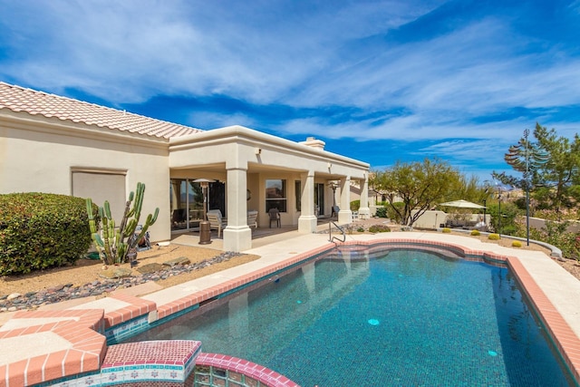 outdoor pool featuring a patio and an in ground hot tub