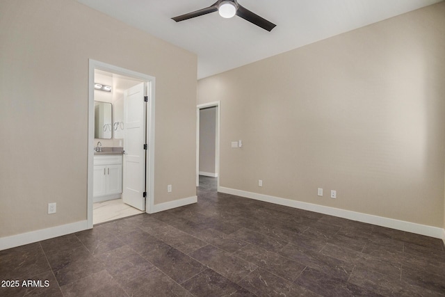 unfurnished bedroom featuring ensuite bathroom, ceiling fan, and sink