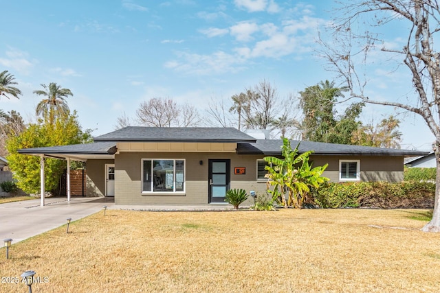 view of front facade featuring an attached carport, concrete driveway, brick siding, and a front yard