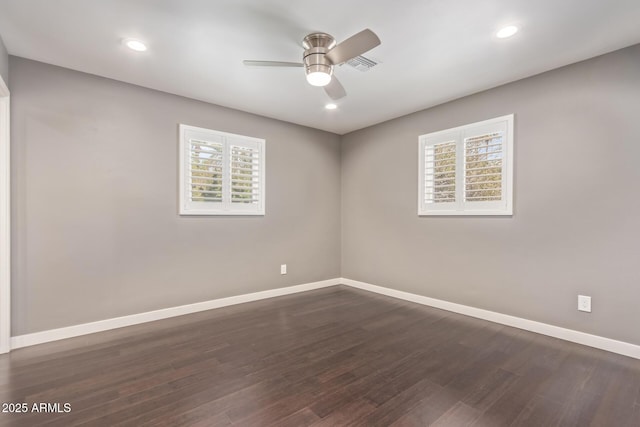 unfurnished room featuring dark wood finished floors, recessed lighting, visible vents, a ceiling fan, and baseboards