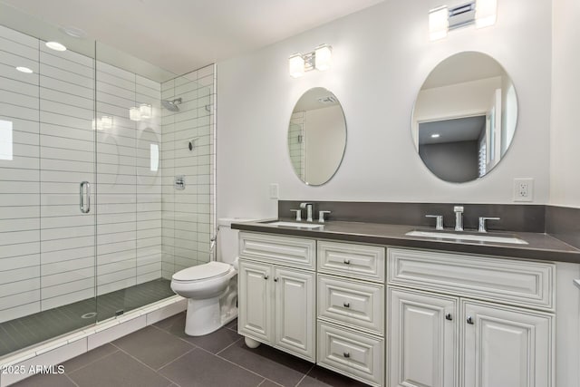 full bath with tile patterned flooring, a sink, a shower stall, and toilet