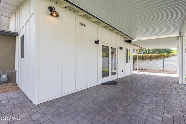 view of patio / terrace featuring fence and french doors