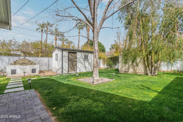 view of yard featuring an outbuilding, a storage unit, and a fenced backyard