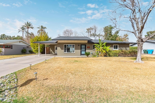 ranch-style home featuring an attached carport, brick siding, driveway, and a front yard