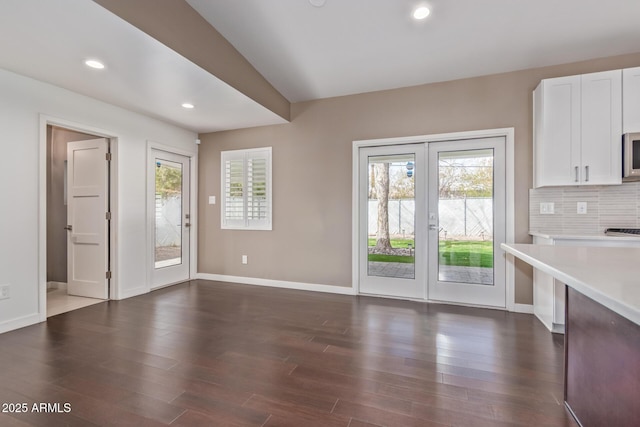 entryway featuring recessed lighting, dark wood-style flooring, plenty of natural light, and baseboards