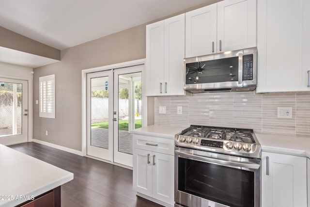 kitchen with plenty of natural light, tasteful backsplash, stainless steel appliances, and light countertops