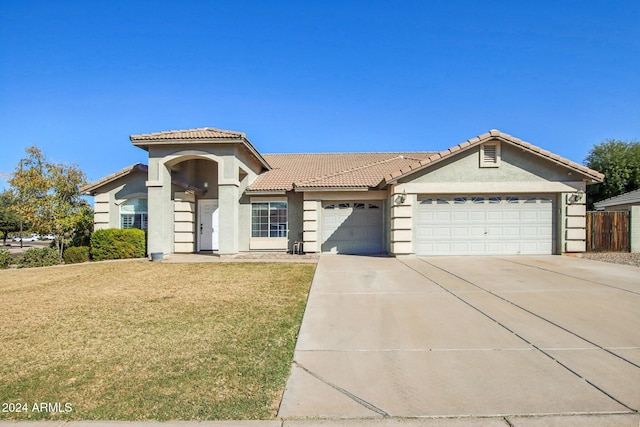 view of front of property with a garage and a front lawn