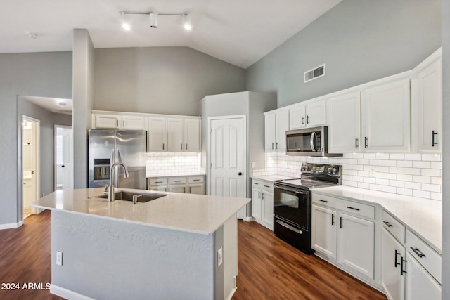 kitchen featuring dark wood-type flooring, white cabinets, sink, an island with sink, and appliances with stainless steel finishes