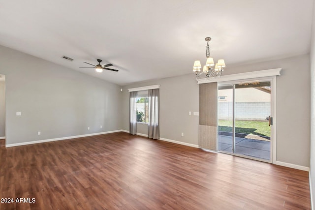 empty room with ceiling fan with notable chandelier and dark wood-type flooring