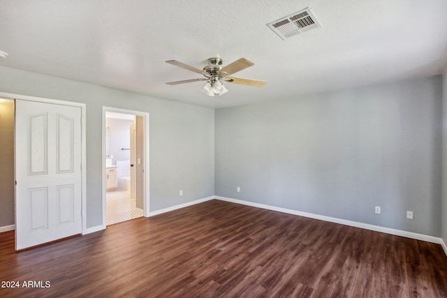 empty room featuring ceiling fan and dark wood-type flooring