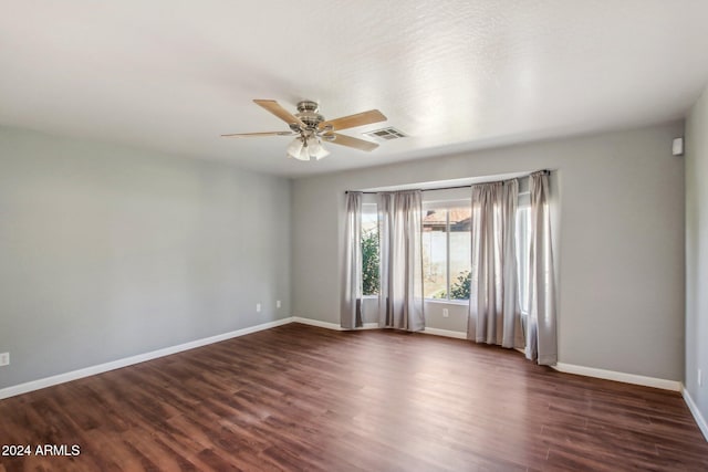 empty room with ceiling fan and dark wood-type flooring