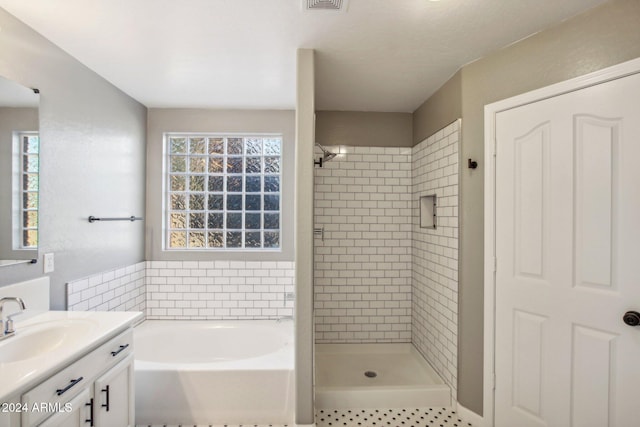 bathroom featuring vanity and plus walk in shower