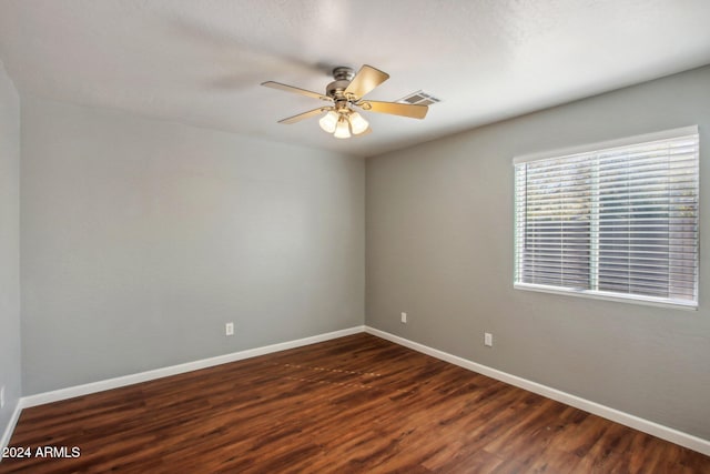 unfurnished room with dark hardwood / wood-style floors and ceiling fan