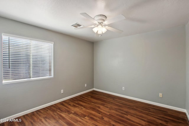 spare room featuring ceiling fan and dark wood-type flooring