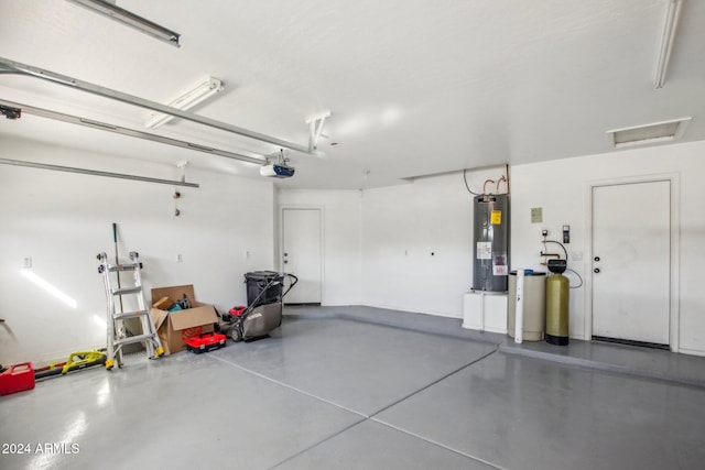 garage with a garage door opener and water heater