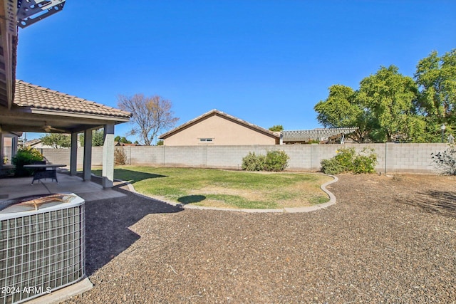 view of yard featuring central AC unit and a patio area