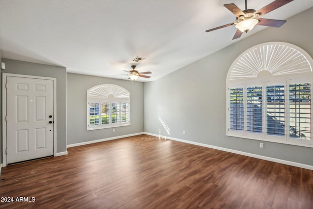 empty room with dark hardwood / wood-style flooring and ceiling fan