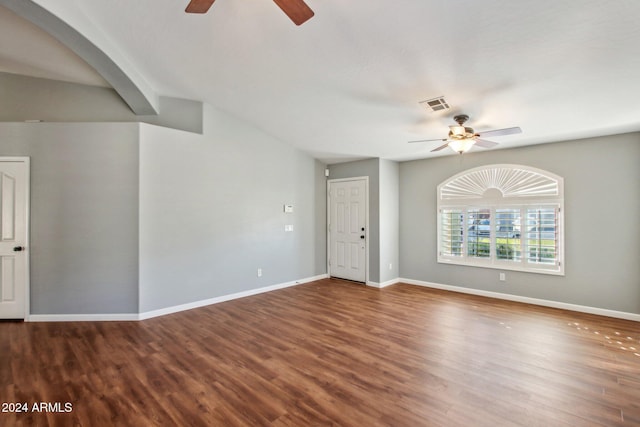 empty room with wood-type flooring and lofted ceiling