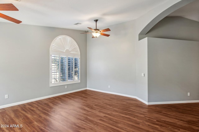 unfurnished room with hardwood / wood-style floors, ceiling fan, and vaulted ceiling