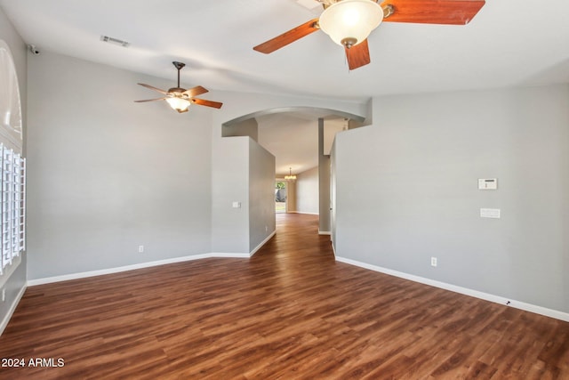 empty room with dark hardwood / wood-style floors, ceiling fan, and lofted ceiling